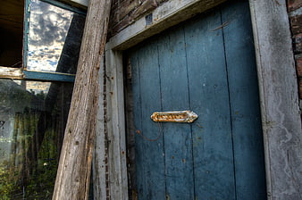 Weathered Blue Wooden Door with Rusty Mail Slot