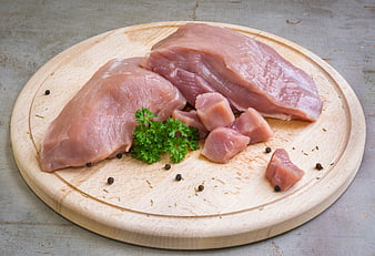 Raw Pork Fillet And Chops On Wooden Cutting Board With Parsley