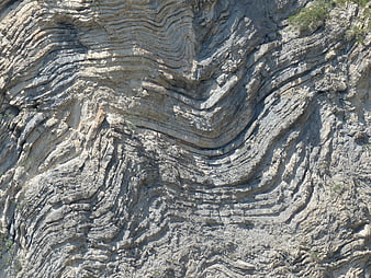 Folded Limestone Rock Strata And Geological Layering Texture