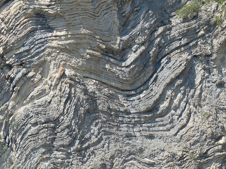 Folded Limestone Rock Strata And Geological Layering Texture