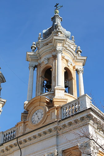 Baroque church bell tower against blue sky