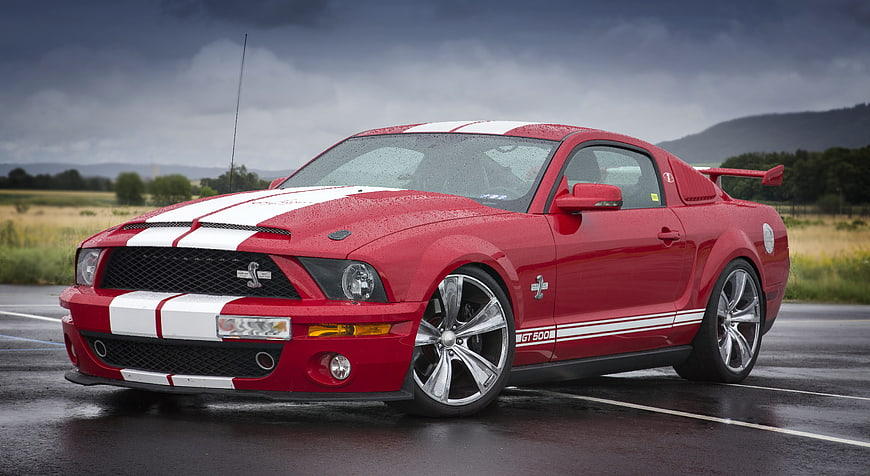 Red Ford Mustang Shelby GT500 Muscle Car On Wet Asphalt