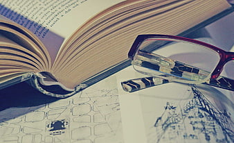 Open book with glasses and architectural sketches