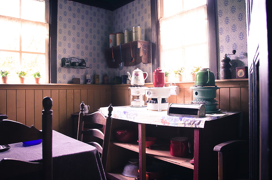 Vintage kitchen interior with retro appliances and patterned wallpaper