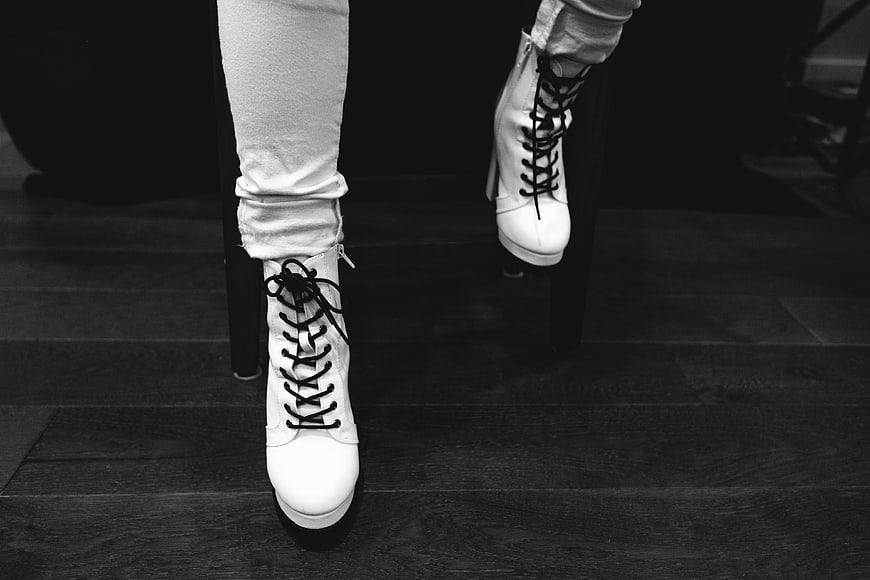 Black and white fashion shot of white lace-up boots