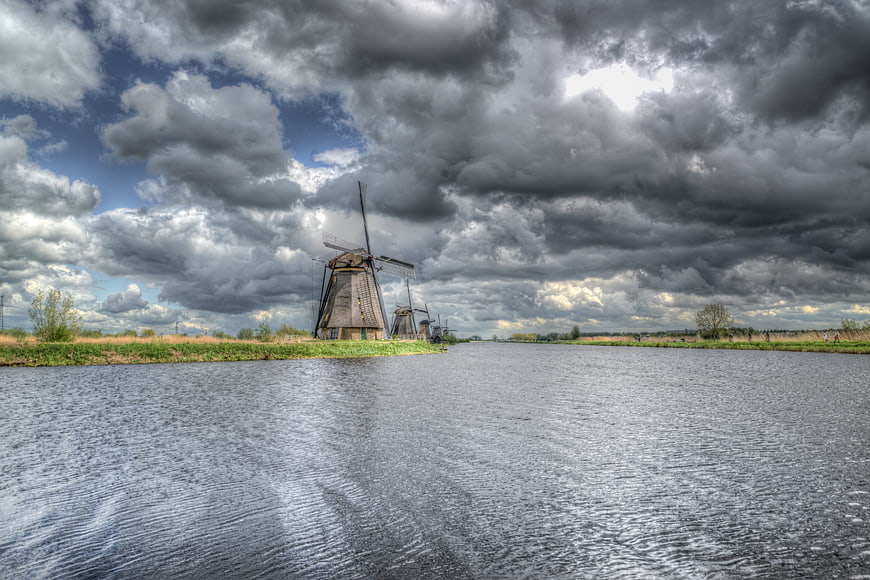 Dramatic Dutch Windmills at Kinderdijk Under Stormy Sky