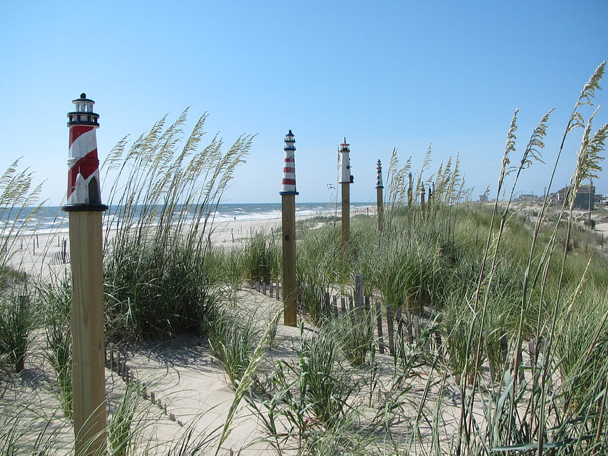 Miniature Lighthouses on Sandy Beach Dunes with Sea Grass