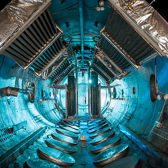 Interior of a blue-lit industrial vacuum chamber