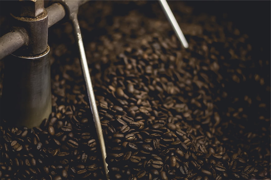 Close-up of coffee beans roasting in industrial machine