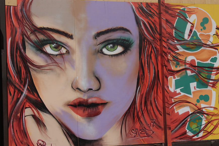 Vibrant Street Art Portrait of Woman with Green Eyes