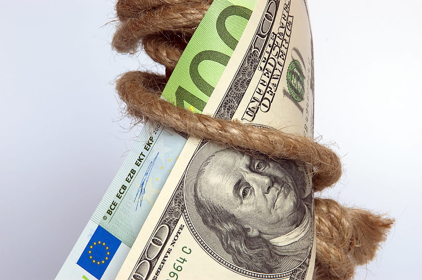 Dollar and Euro Banknotes Tied with Rope Concept