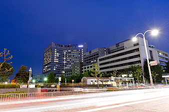 Night view of modern hospital with light trails