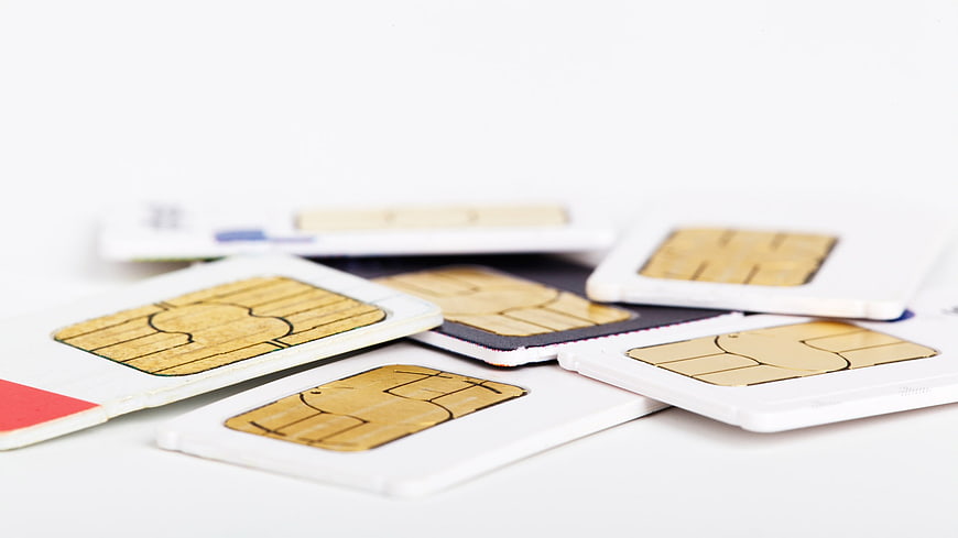 Scattered SIM Cards on White Background