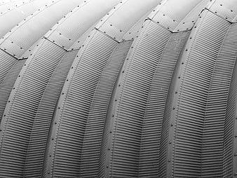 Close-up of corrugated metal roof with rivets and industrial texture