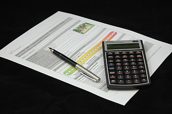 Financial Calculator And Pen On Real Estate Energy Certificate Document