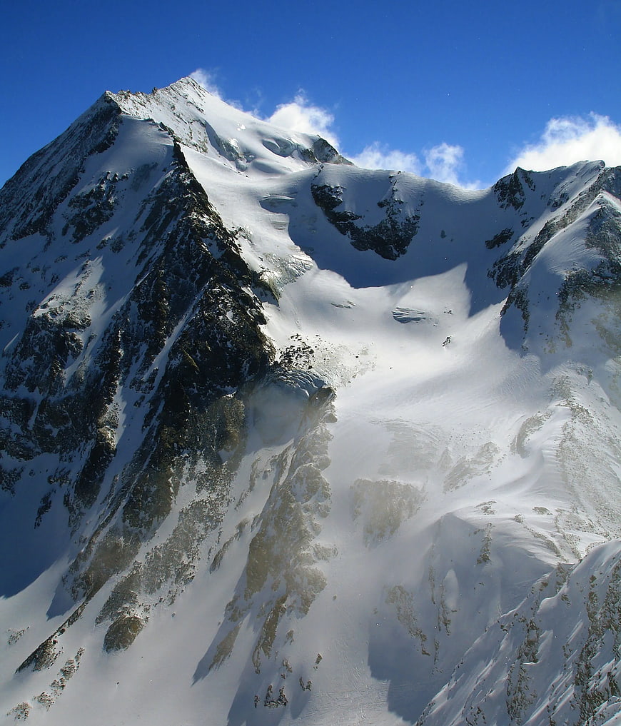Majestic Snow-Covered Mountain Peak Under Blue Sky