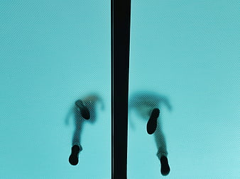 Silhouette of feet walking on frosted glass