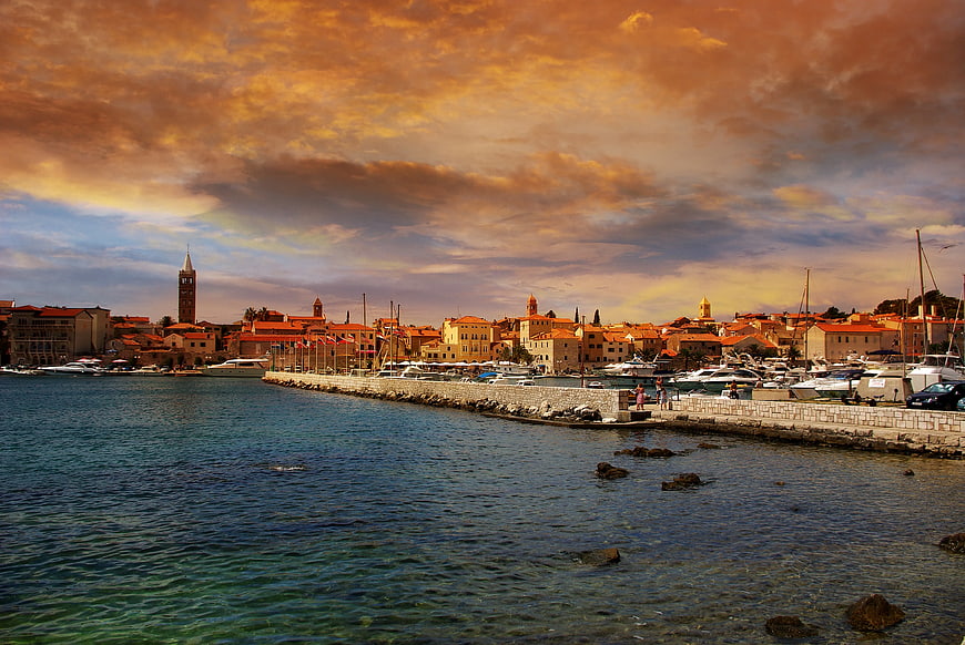 Dramatic sunset over coastal European harbor city