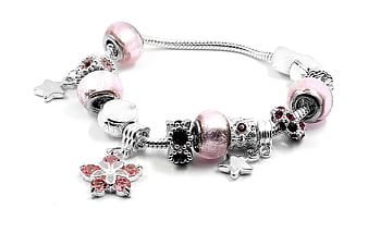 Silver charm bracelet with pink beads and star pendants on white background