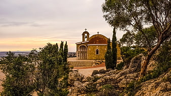 Traditional Greek Orthodox Church on Hilltop at Sunset