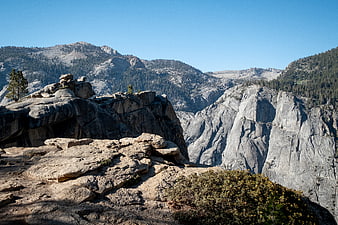 Scenic granite mountain landscape with rocky cliffs and pine trees
