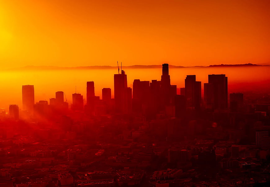 Dramatic Orange Sunset Over City Skyline Silhouette
