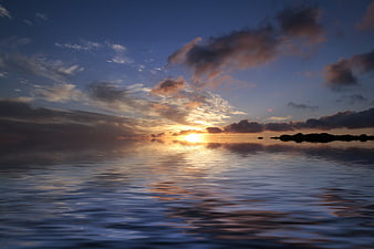 Serene Sunset Over Calm Ocean with Distant Island Silhouette