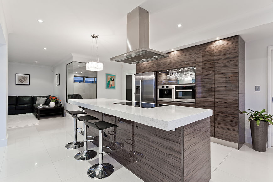 Modern kitchen island with dark wood cabinets and white countertop