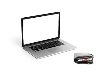 Laptop with blank screen and wallet with credit cards on white background