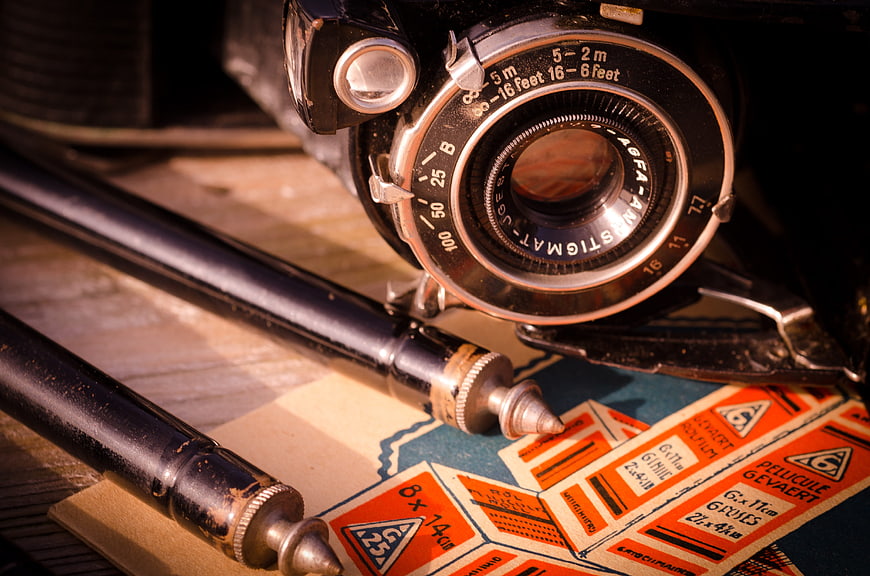 Vintage Agfa Camera and Film Pack on Wooden Table
