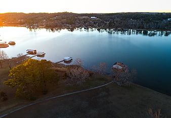 Aerial View of Lake with Boathouses at Sunset