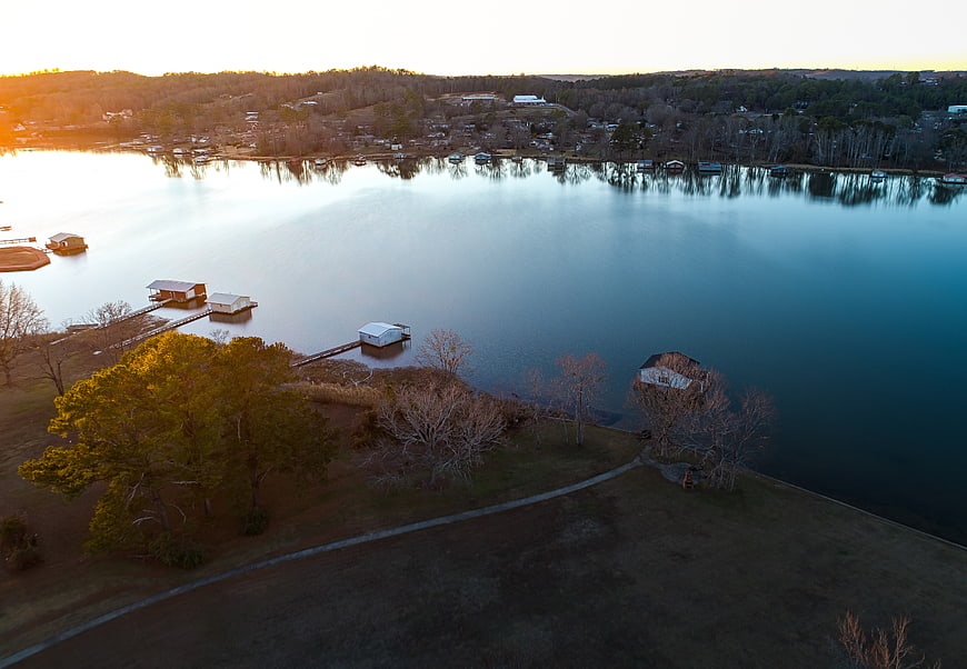 Aerial View of Lake with Boathouses at Sunset