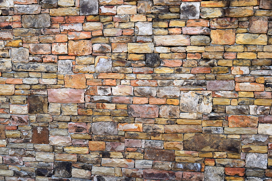 Weathered Multi-Toned Stone Wall Texture Background