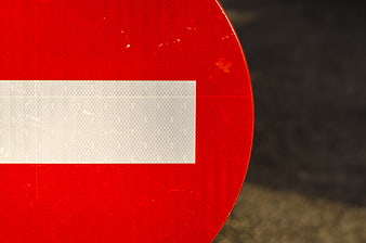 Close-up of Red No Entry Traffic Sign with White Bar
