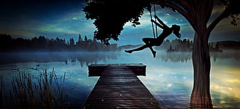 Silhouette of Girl on Swing Over Misty Lake at Dusk