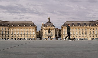 Man walking dog in Place de la Bourse, Bordeaux