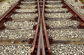Close-up of rusty railroad track junction on gravel ballast