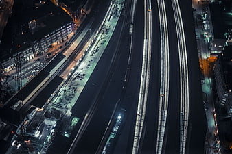 Aerial Night View of Urban Train Tracks and City Lights