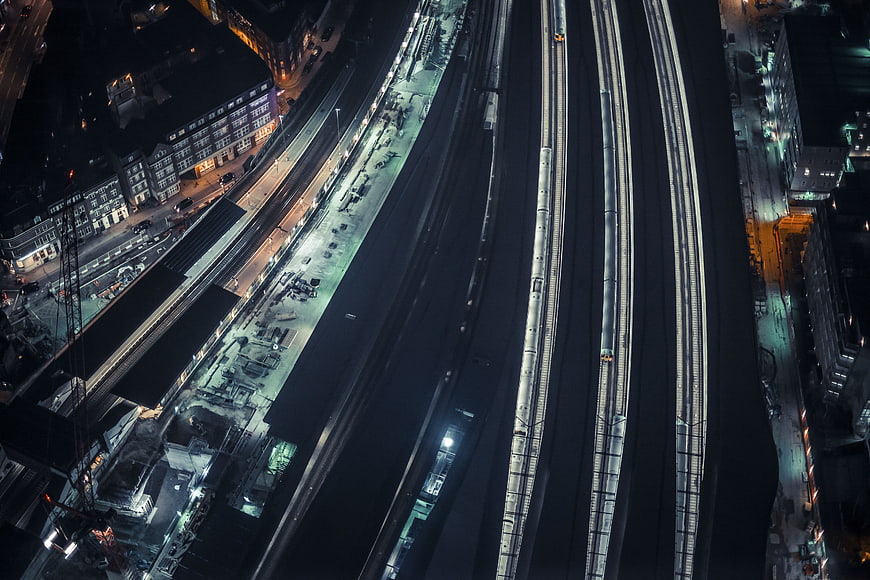 Aerial Night View of Urban Train Tracks and City Lights