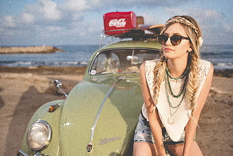 Blonde Woman with Braids Leaning on Vintage Green Beetle at Beach