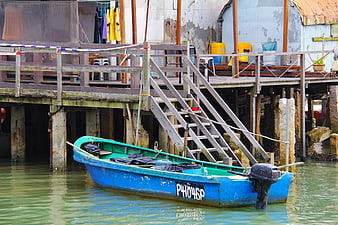 Blue Fishing Boat Moored Near Stilt House in Tai O, Hong Kong