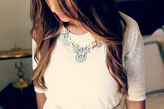 Woman Wearing Statement Necklace and White Lace Top