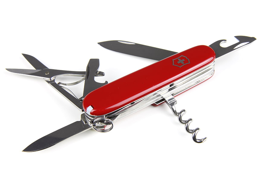 Red Swiss Army Knife with Tools Opened on White Background