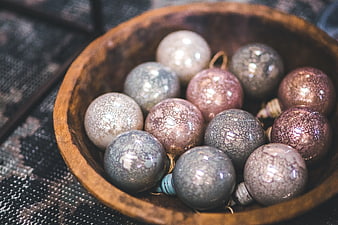 Vintage crackle glass Christmas ornaments in wooden bowl