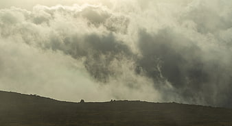 Dramatic Storm Clouds Over Silhouetted Mountain Ridge