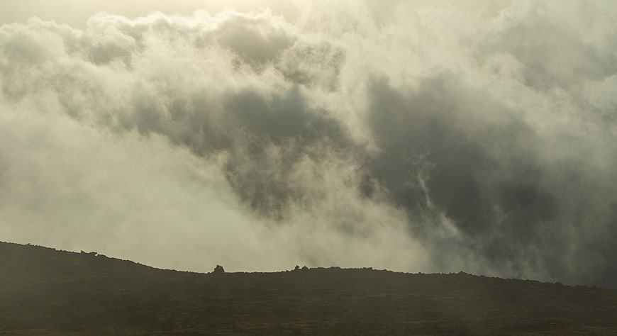 Dramatic Storm Clouds Over Silhouetted Mountain Ridge