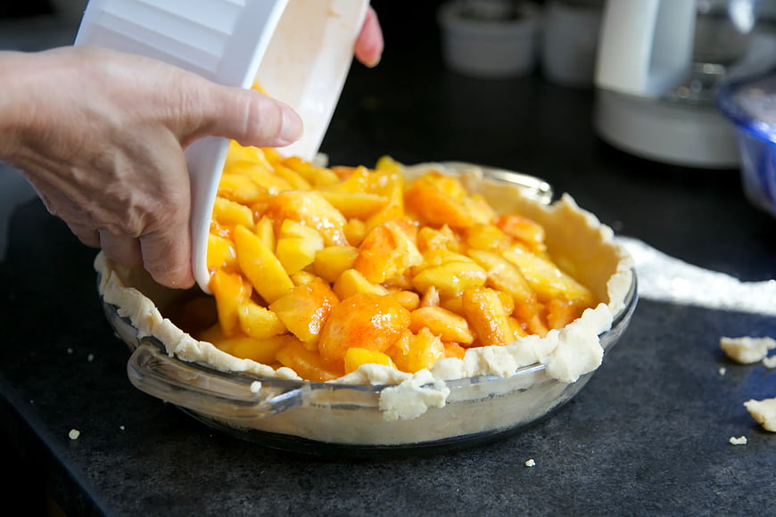 Pouring Peach Filling into Pie Crust