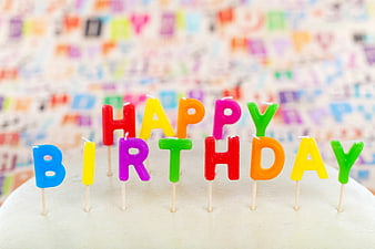 Colorful Happy Birthday Letter Candles on White Cake