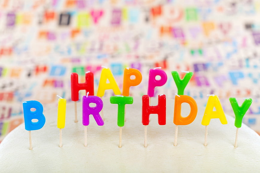 Colorful Happy Birthday Letter Candles on White Cake