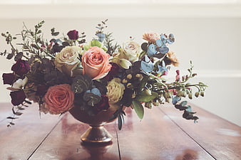 Elegant Floral Arrangement with Roses and Eucalyptus on Wooden Table